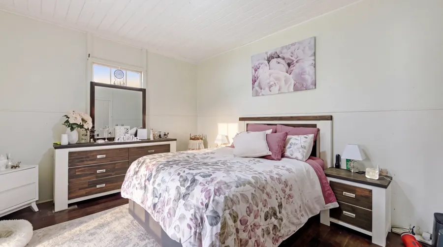 Bedroom with timber floors and garden outlook