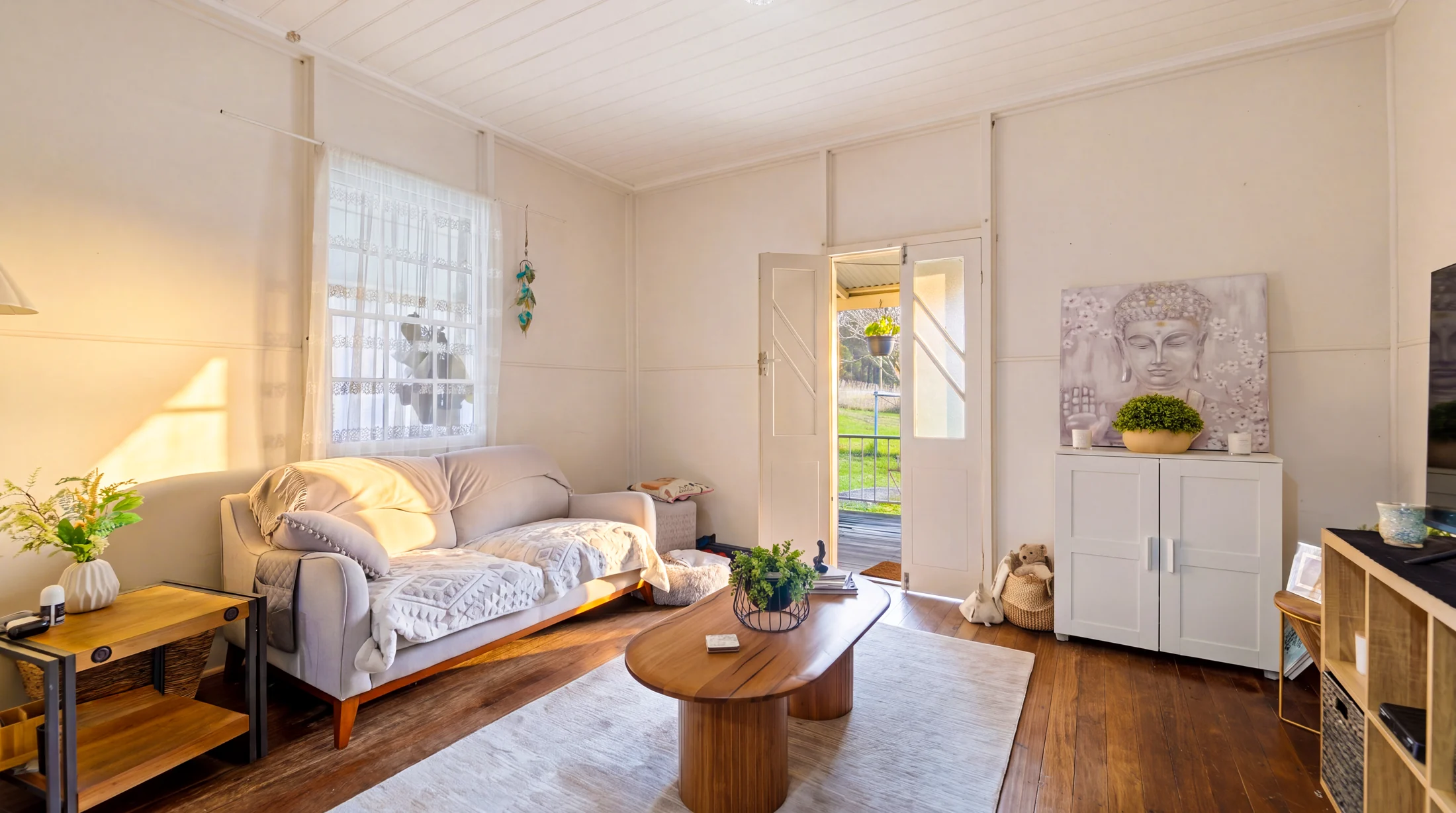 The living room with timber floors and warm afternoon light