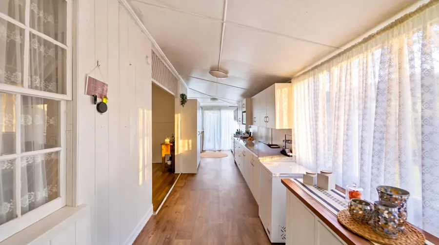 Long enclosed sunroom beside the living spaces
