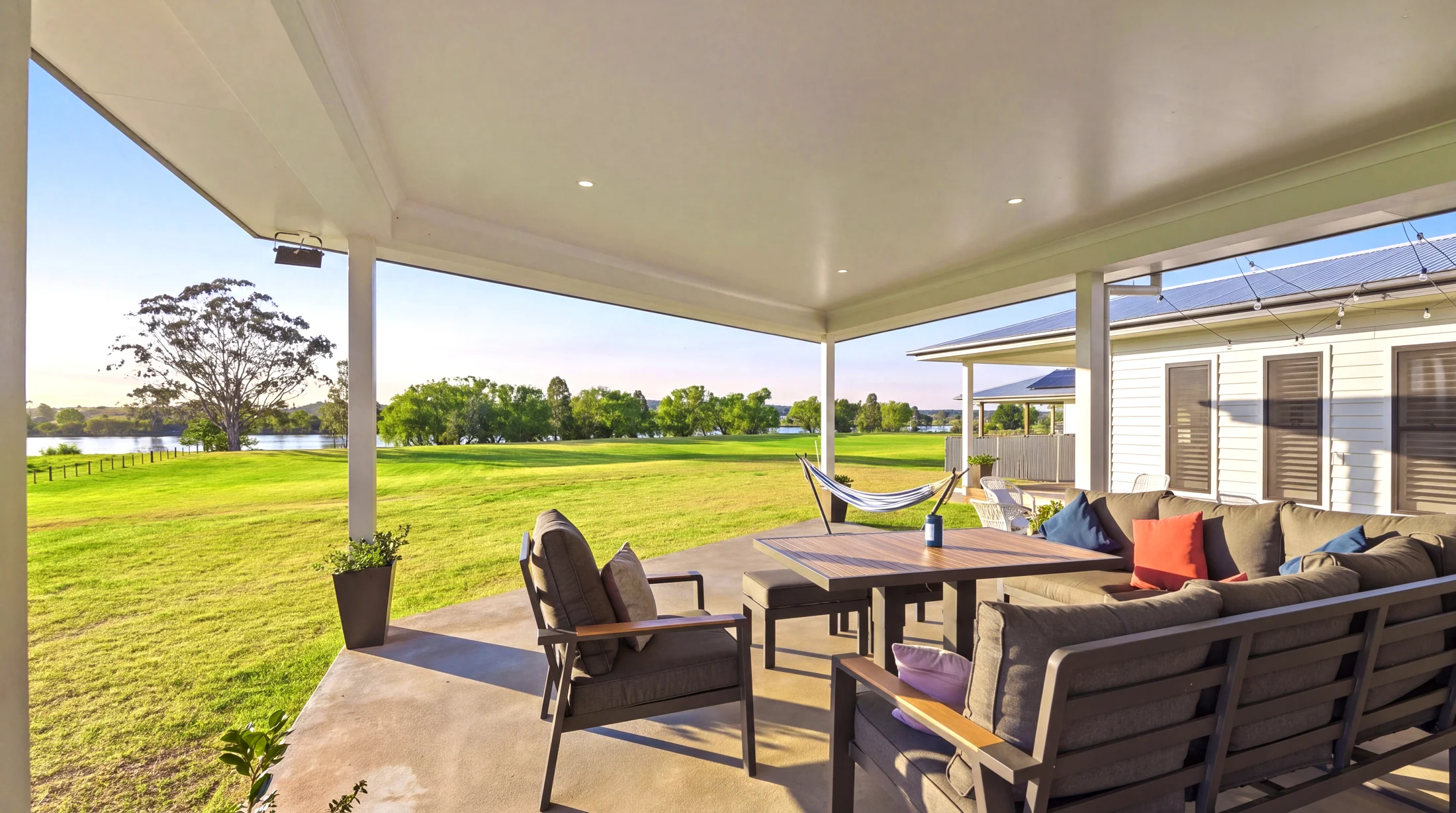 Covered outdoor living looking across the lawn