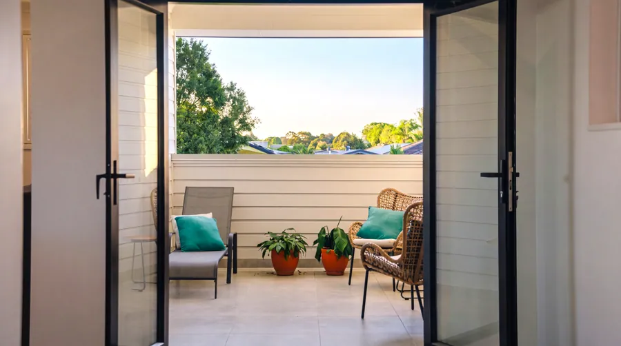 French doors opening onto a sheltered balcony