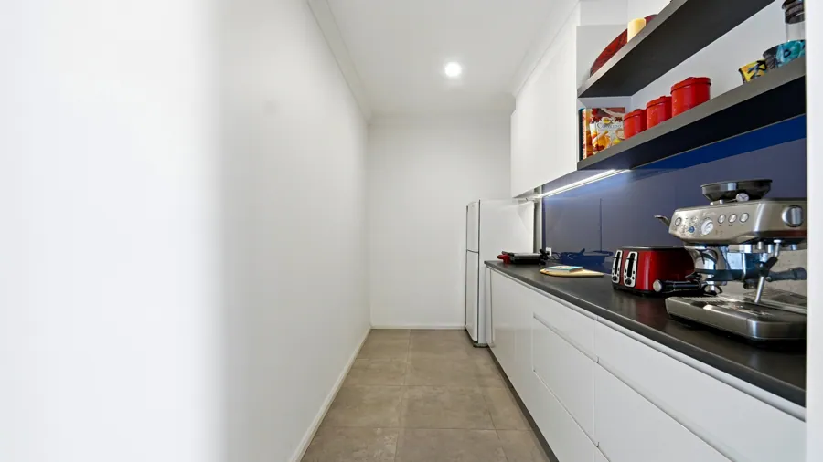 Butler’s pantry with storage and a second work surface