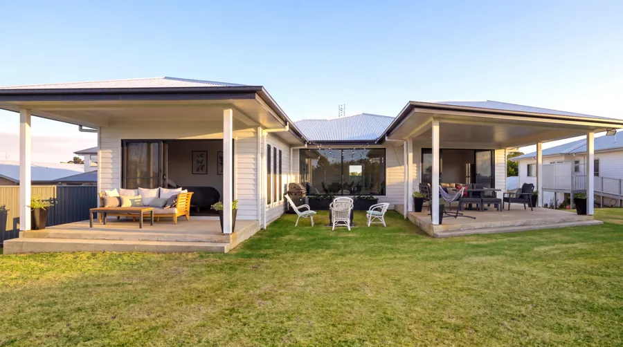 The rear of the home opening onto the lawn