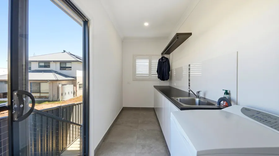 Laundry with bench space and an external door