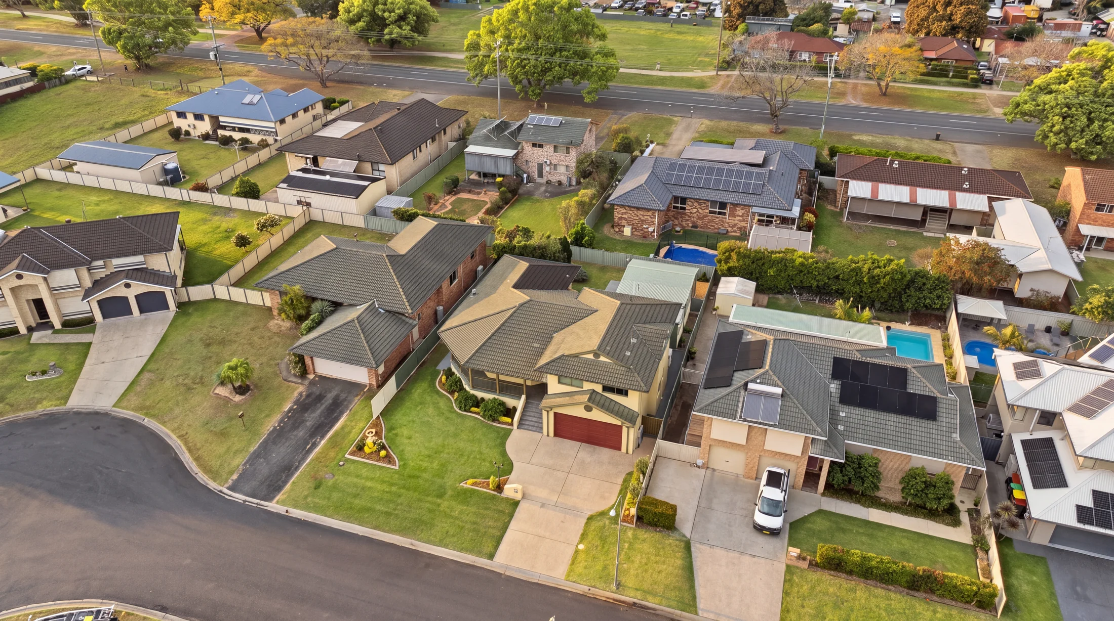 The home, driveway and surrounding homes from above